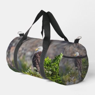 Bald eagle sitting on the rock duffle bag