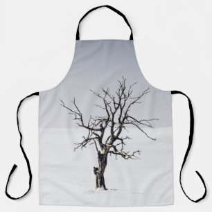BARE TREE IN THE MIDDLE OF SNOW APRON
