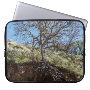 Bare tree on mountain during day laptop sleeve