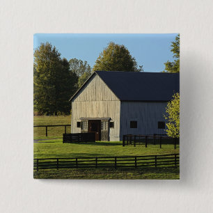 Barn on thoroughbred horse farm at sunrise, 15 cm square badge