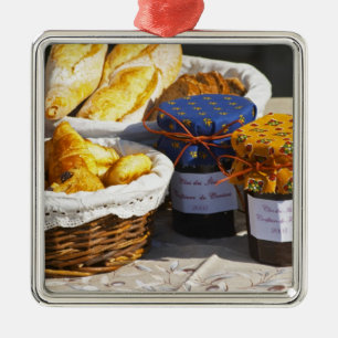 Basket with croissants and chocolate breads. metal tree decoration