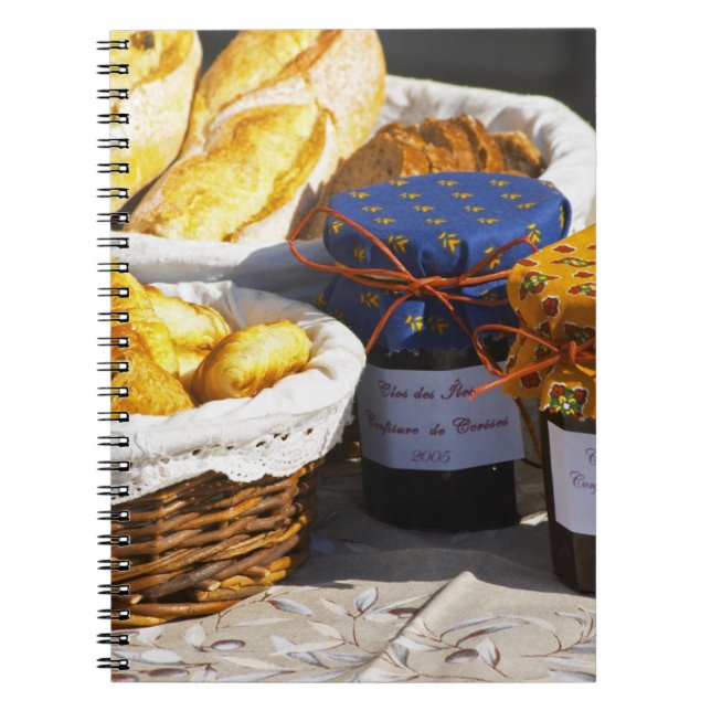 Basket with croissants and chocolate breads. spiral notebook (Front)