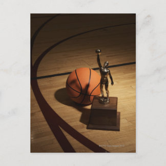 Basketball and trophy on basketball court, postcard
