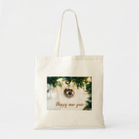 Bauble on green tree Tote Bags