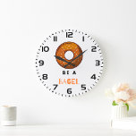 Be a Bagel Funny Food Pun Bagel Lover Design<br><div class="desc">Add a touch of humour to your space with this “Be a Bagel” wall clock. Featuring a playful bagel illustration and a witty pun, this clock is perfect for food lovers, brunch enthusiasts, and anyone who enjoys quirky decor. Made with high-quality materials and a sleek design, it’s a fun and...</div>