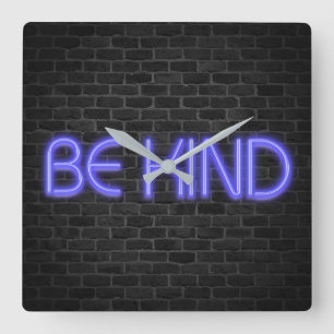 BE KIND text in neon lights on brick Square Wall Clock