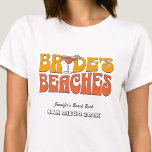 Beach Bachelorette Party Groovy Bride's Beaches T-Shirt<br><div class="desc">Make a splash at your upcoming bachelorette party with this stunning beach bachelorette party personalised t-shirts. Whether you're celebrating a bach trip, a girls' vacation, or a best friends' holiday, this custom beach bachelorette party t-shirts are the perfect addition to your unforgettable getaway. Add a personal touch to your bachelorette...</div>