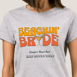 Beach Bachelorette Party Retro Beachin Bride T-Shirt<br><div class="desc">Make a splash at your upcoming bachelorette party with this stunning beach bachelorette party personalised t-shirts. Whether you're celebrating a bach trip, a girls' vacation, or a best friends' holiday, this custom beach bachelorette party t-shirts are the perfect addition to your unforgettable getaway. Add a personal touch to your bachelorette...</div>