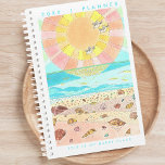 Beach Happy Place 2024 Planner<br><div class="desc">Appreciate the beauty of original and unique art as you plan your days, weeks, and months ahead. Stay organised and inspired and embrace productivity and creativity with our 2024 Happy Place Monthly Planner featuring a charming illustration of a seashell filled beach at sunrise. The cheerful and joyous vibe, accompanied by...</div>