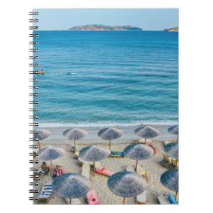 Beach lounge on seashore facing the sea notebook