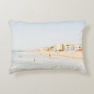 BEACH NEAR BUILDING AT DAYTIME DECORATIVE CUSHION
