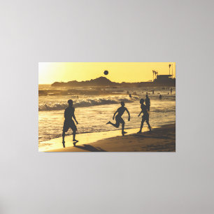 Beach Soccer Game at Golden Sunset Shore Canvas Print