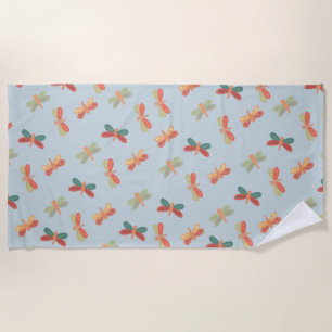 Beach towel with cheerful dragonfly pattern.