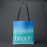 Beach Watercolor Ocean Blue Green Tote Bag<br><div class="desc">This beach design features distressed text on a watercolor ocean blue and green background. Click the customise button for options for modifying or adding text! Variations of this design, additional colours, as well as coordinating products are available in our shop, zazzle.com/store/doodlelulu. Contact us if you need this design applied to...</div>