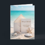 Beach Wedding Christmas With Starfish Holiday Card<br><div class="desc">A blank card and envelope rest on a sandy beach surrounded by seashells,  a starfish,  and a turquoise ocean background for newlyweds 1st Christmas together.
All text can be changed.</div>