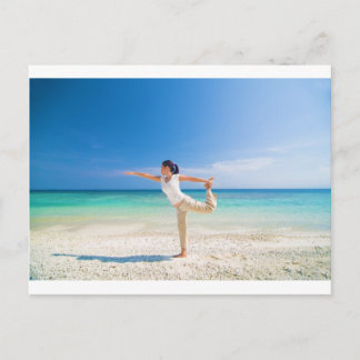 beach yoga performed by a matured asian female postcard