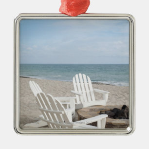 beachfront house with adirondack chairs and metal tree decoration