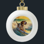 Beagle Beach Surfing Painting Ceramic Ball Christmas Ornament<br><div class="desc">Immerse yourself in the playful world of canine adventure with this captivating painting. A spirited dog takes to the waves, skilfully riding the surf on a sun-kissed beach. The vibrant artwork beautifully captures the essence of beachside excitement as the dog fearlessly rides the waves, embodying the spirit of fun and...</div>