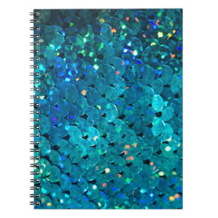 Beautiful and colourful sequins sparkling under th notebook