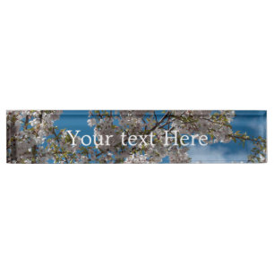 Beautiful cherry blossoming tree against blue sky. nameplate