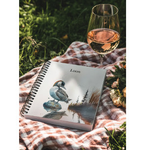 beautiful loon on a rock in watercolor notebook