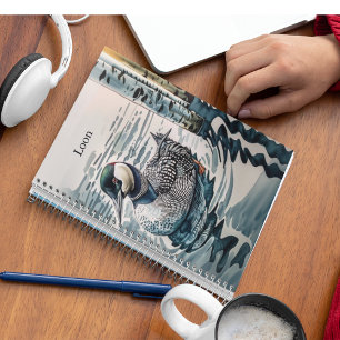 beautiful loon on water in watercolor notebook
