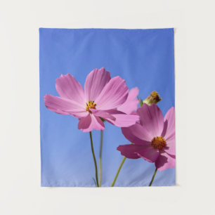 beautiful pink flowers hugging a clear blue sky tapestry