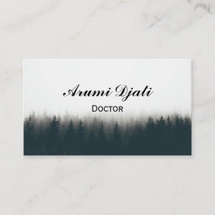 Beautiful shot of a thick forest in fog with pine business card