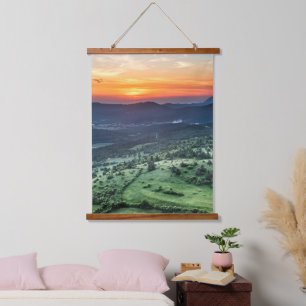 Beautiful sunset behind green fields hanging tapestry