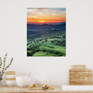 Beautiful sunset behind green fields poster