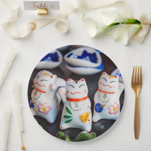 Beckoning cat figurines paper plate