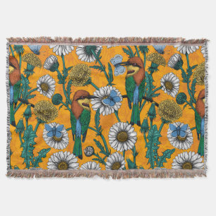 Bee-eaters, blue butterflies and daisies on orange throw blanket