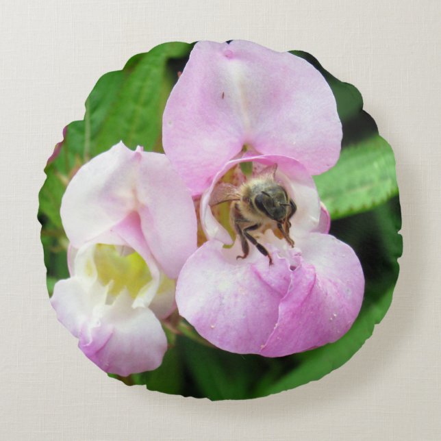 Bee emerging from a sweet pea flower round cushion (Front)