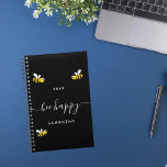 Bee happy black cute bumble bees monogram 2024 planner<br><div class="desc">Decorated with happy,  smiling yellow and black  bumble bees. A chic black background. White hand lettered script with swashes and the text: Bee Happy.  Personalise and add your name and a year. Perfect for school,  work or organising your personal/family life.</div>