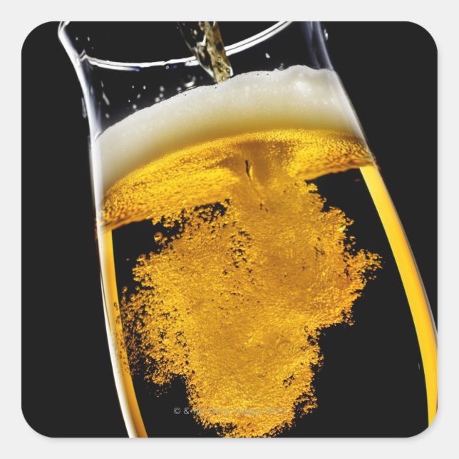 Beer been poured into glass, studio shot square sticker (Front)