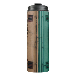 Beige and green concrete spiral stairs beside buil thermal tumbler