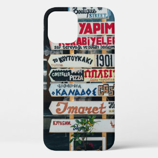 BEIGE RED AND BROWN SIGNAGES ON BEIGE STAND AT DAY iPhone 12 CASE