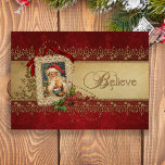 Believe Gold and Red Damask Vintage Christmas Holiday Card<br><div class="desc">Unique, richly textured, elegant and ornate vintage style design featuring Victorian-era Santa image in an ecru lace frame decorated with red ribbon, gold flourish, sparkling beaded swirls, and poinsettias on a red subtly textured damask background. Center band of antique parchment trimmed in glittering gold lace in a holly pattern with...</div>