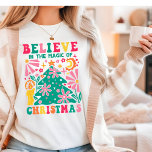 Believe In The Magic Of Christmas Retro Boho Tri-Blend Shirt<br><div class="desc">Believe In The Magic Of Christmas Retro Boho Festive Holiday Tri-Blend Shirt features the text "Believe In The Magic Of Christmas" in modern script typography accented with colourful Matisse style Christmas tree, flowers and a candle. Perfect for Christmas gifts, Christmas parties and holiday celebrations, birthdays and more. Created by Evco...</div>
