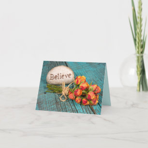 Believe text on rock with roses card