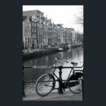 Bicycle by Canal Poster<br><div class="desc">Netherlands,  Amsterdam,  bicycle parked by canal (B&W) | Tancredi J. Bavosi | AssetID: 200529149-001</div>
