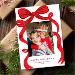 Big Bold Bright Red Bow Christmas Photo Holiday Card<br><div class="desc">This modern yet festive holiday photo card features a large hand-drawn bow in red over a simple white background. There is one vertical photo and an editable greeting. The back of the card is blank but you could easily add another photo and/or additional text. The background, greeting, and text colors...</div>
