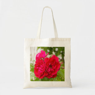 Big red roses in the garden tote bag