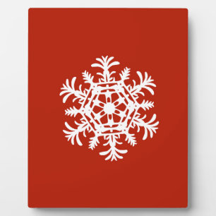 Big white snowflake on red plaque
