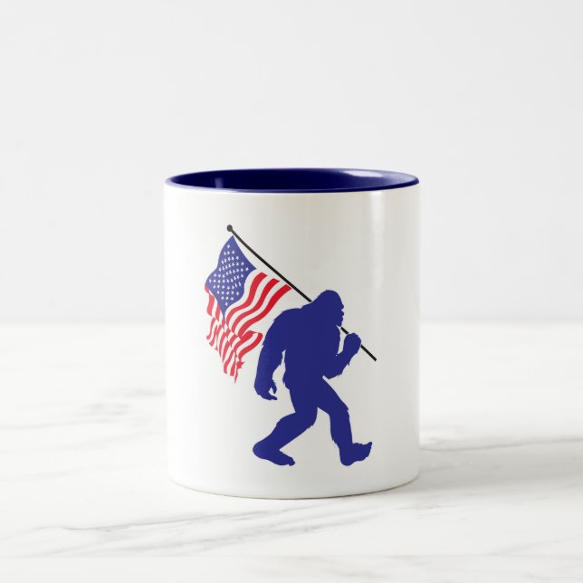 Bigfoot carrying the American Flag Two-Tone Coffee Mug (Center)