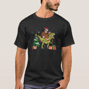 Bigfoot Riding Dinosaur Christmas Pajama Santa Hat T-Shirt