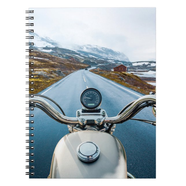 Biker rides a motorcycle on a slippery road throug notebook (Front)