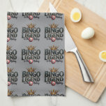 Bingo Legend Crowned in Gold Retro Typography Tea Towel<br><div class="desc">Celebrate your love for bingo with this bold and regal design featuring the phrase "Bingo Legend in the Making" in striking retro typography, topped with an ornate golden crown. The deep, rich hues and vintage aesthetic give this artwork a timeless appeal, perfect for those who enjoy the thrill of the...</div>
