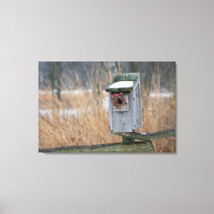 Bird, nest box with holiday wreath in winter canvas print