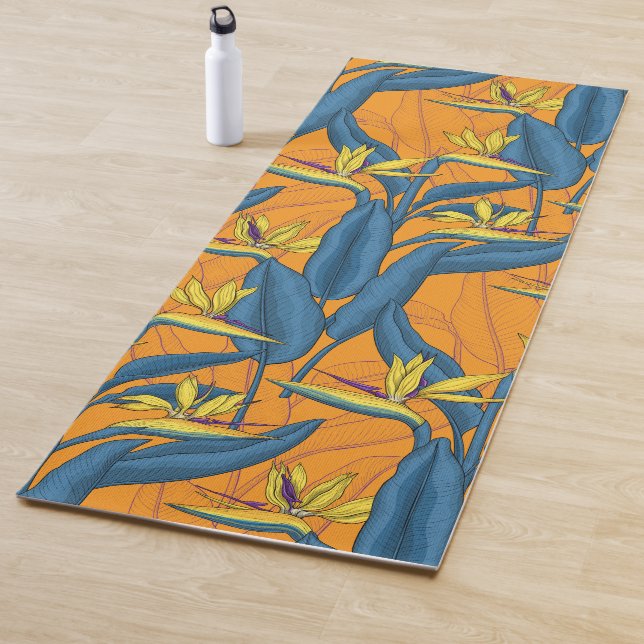 Bird of paradise flowers on orange yoga mat (In Situ)